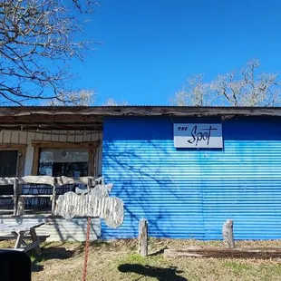 a blue house with a sign on it