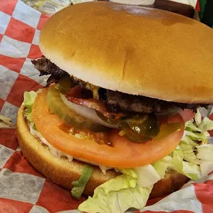 a hamburger with lettuce, tomato, and onion