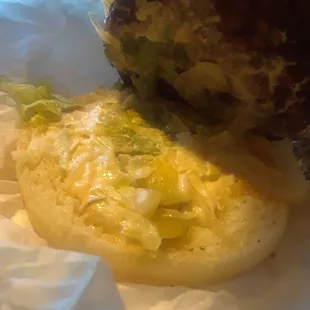 Whilted lettuce and a couple pickles with a small amount of what is supposed to be chipotle sauce.