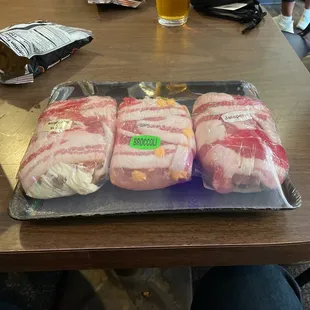 a tray of bacon wrapped in plastic