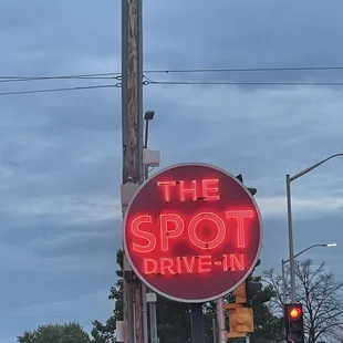 a neon sign for the spot drive - in