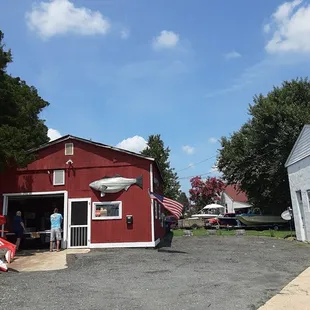 a red building and a man standing in front of it
