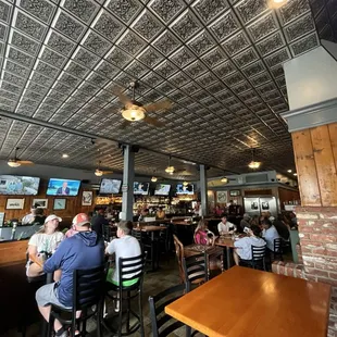 people sitting at tables in a restaurant