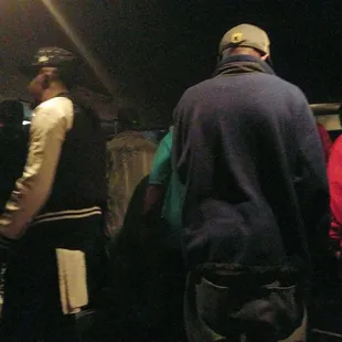a group of people standing outside at night