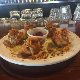Mac&amp;Cheese Balls with fried sweet potato strings and cranberry sauce.