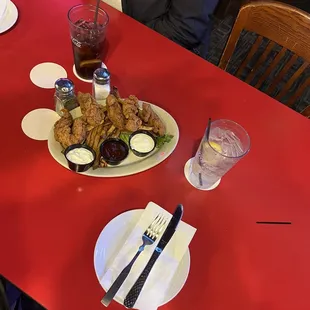 a woman sitting at a table with a plate of food