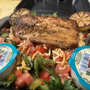 a salad with grilled fish