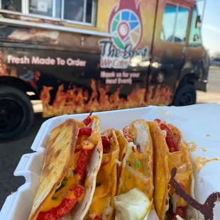three tacos in a styrofoam container
