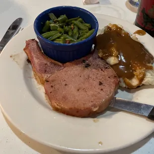 a plate of food with green beans and gravy