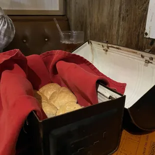 Bread kept warm in an old lunch box, like they'd use in oil fields