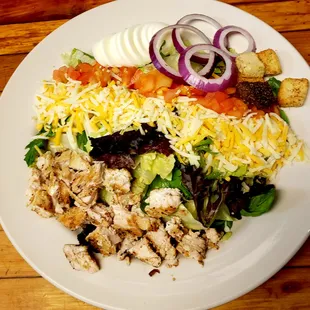 a white plate of food on a wooden table