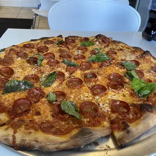 a pepperoni and basil pizza