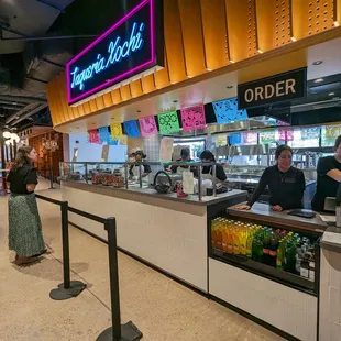 a line of people at a food court