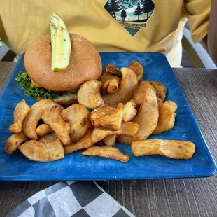 a sandwich and fries on a blue plate