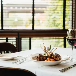 a plate of food and a glass of wine