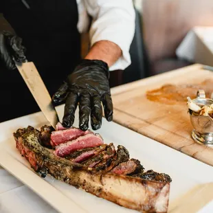 a chef cutting a steak