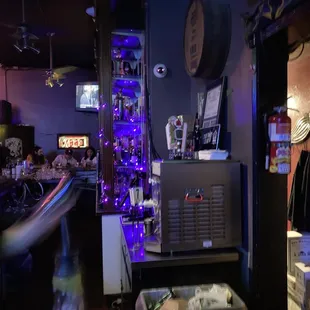 a room with a television and a refrigerator