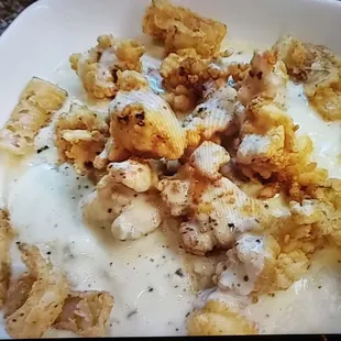 Our flavor for days,crispy lobster bites on creamy grits topped with  sauce