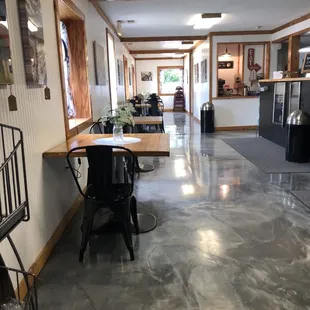 a long hallway with tables and chairs