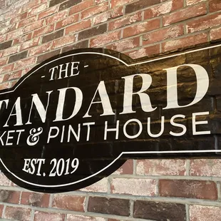 a sign for the standard market and pint house