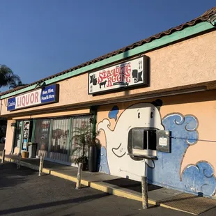 Don't be fooled by the tiny little window. Walk into the liquor store to order.