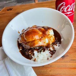 Loco Moco with a thick burger patty and carmelized onions under the egg. Sauce is strong and flavorful. I enjoyed it!