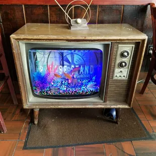 n old television with a fish tank on top