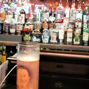 a glass of beer on a bar counter