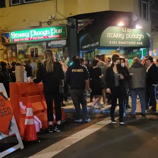 a crowd of people standing in a street
