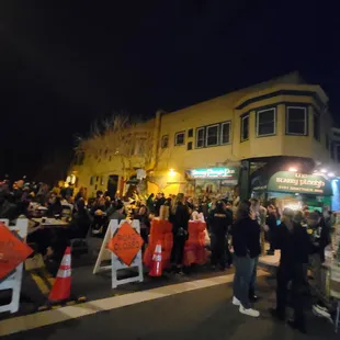 a crowd of people standing on the street