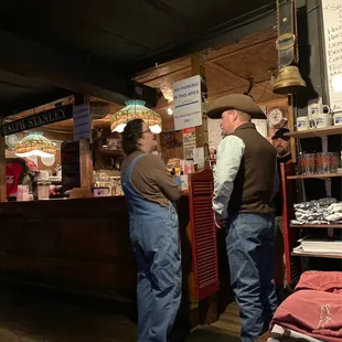 two men standing at a counter