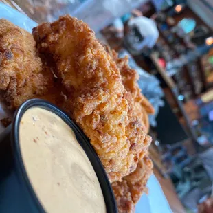 a plate of fried food with dipping sauce