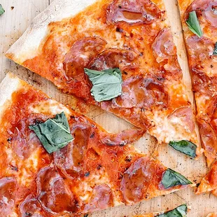 several slices of pizza on a cutting board