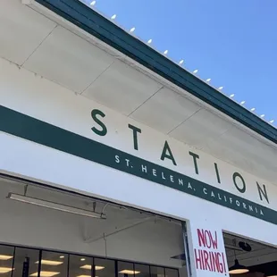 a woman standing in front of the station