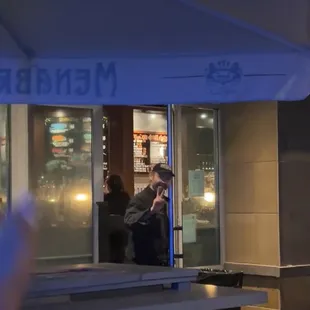 a man standing in front of a bar