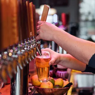 a person pouring a drink at a bar