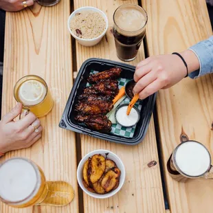 a table full of beer and food