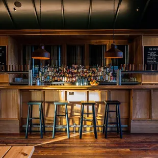 a wooden bar with stools