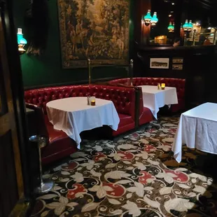 tables and booths with white tablecloths