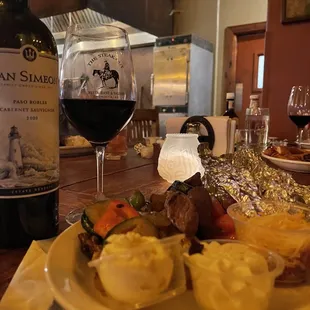 a plate of food and a glass of wine