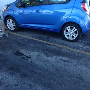 a blue car parked in a parking lot