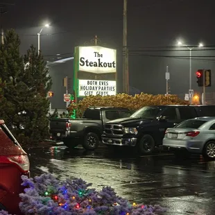 cars parked in a parking lot at night
