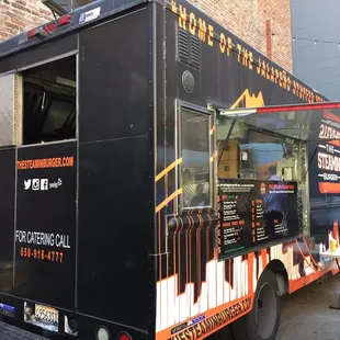  food truck parked in front of a brick building