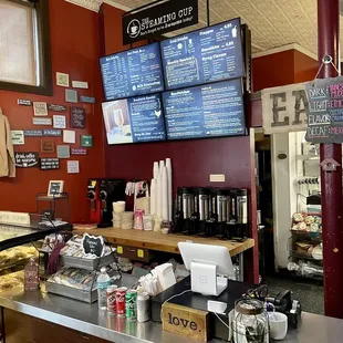 a coffee shop with menus on the wall