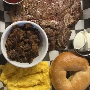 T-Bone steak Breakfast special with cheesy eggs, bagel and a side of burnt brisket ends.