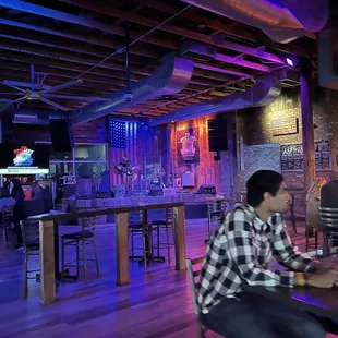 a man sitting at a table in a bar