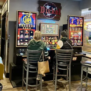 two people sitting at a bar