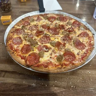 12" pizza with sausage and pepperoni (Milk Duds for scale)