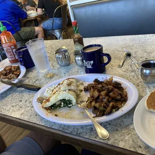 a breakfast of eggs, hash browns, and toast