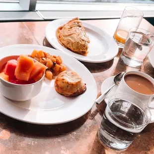 two plates of food and a cup of coffee